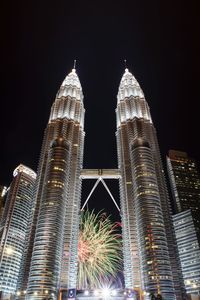 Low angle view of skyscrapers lit up at night