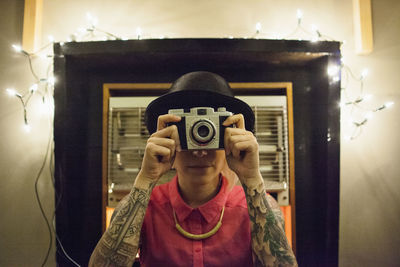 Young woman using a vintage camera