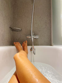Female legs personal perspective relaxing in the bathtub