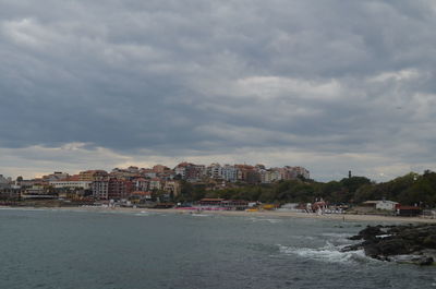 Buildings against cloudy sky