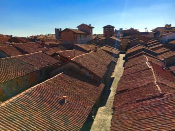 High angle view of houses against blue sky during sunny day