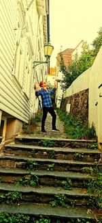 Low angle view of man standing on staircase of building