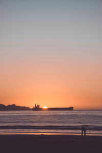 Scenic view of sea against clear sky during sunset