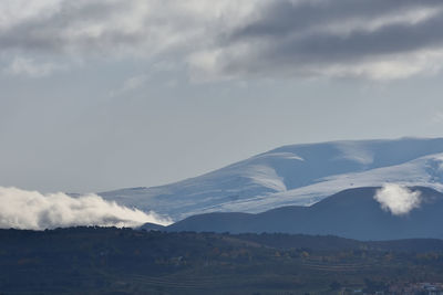 Scenic view of snowcapped mountains against sky