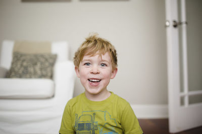 Cheerful boy sitting at home