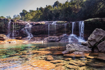 Natural waterfall white water streams with calm clear water at morning