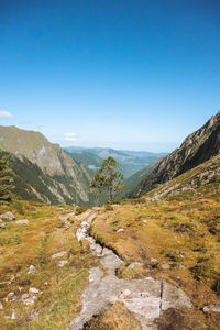 Scenic view of mountains against clear blue sky