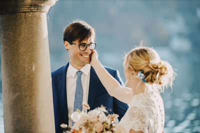 Bride touching on groom's cheek at wedding