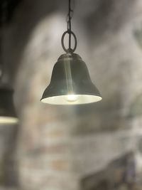 Close-up of light bulb hanging from ceiling