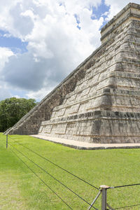 Low angle view of historical building against cloudy sky