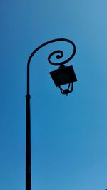 Low angle view of street light against clear blue sky