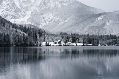 Scenic view of lake by snowcapped mountains