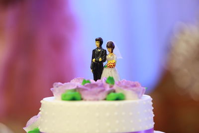 Close-up of figurine on wedding cake