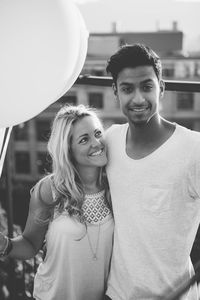 Portrait of young couple standing outdoors