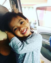 Portrait of happy woman in car