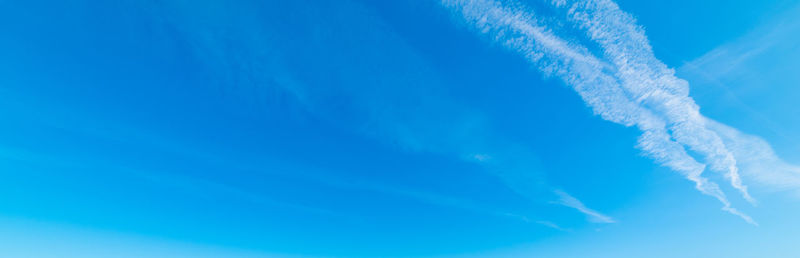 Low angle view of vapor trail against blue sky