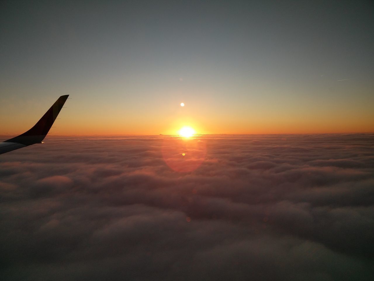 AIRPLANE FLYING IN SKY DURING SUNSET