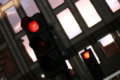 Close-up of illuminated road sign against sky