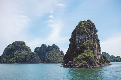 Rock formations in sea against sky