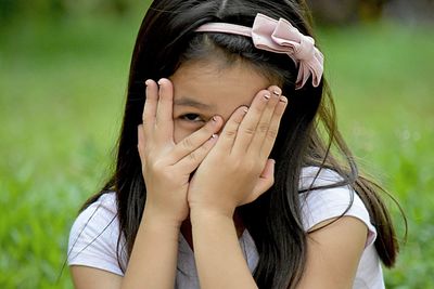 Portrait of woman covering face