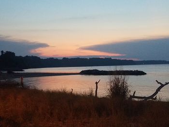 Scenic view of lake against sky during sunset