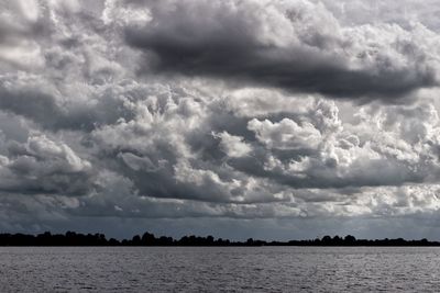 Scenic view of sea against cloudy sky