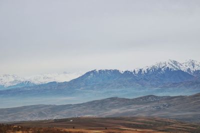 Scenic view of snowcapped mountains against sky