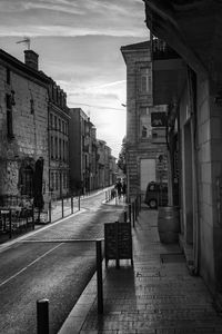 Narrow street amidst buildings in city