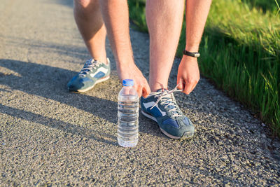 Low section of man running on road