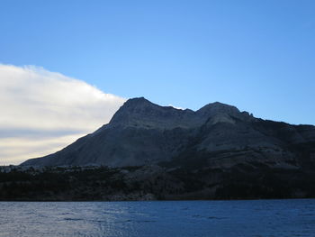 Scenic view of mountains against blue sky