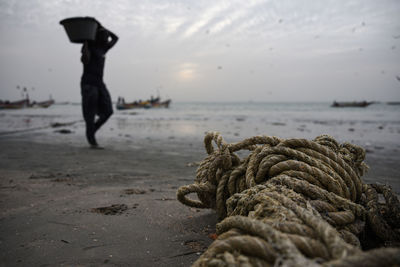 View of rope on beach against sky