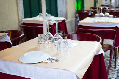 Empty chairs and tables on table at restaurant