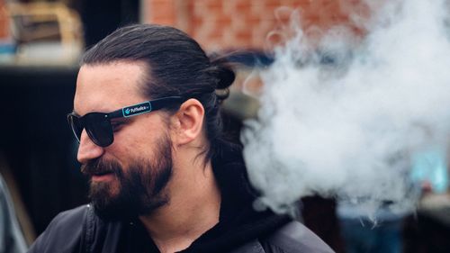 Close-up of man smoking in sunglasses