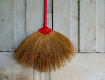 Close-up of red umbrella on floor against wall