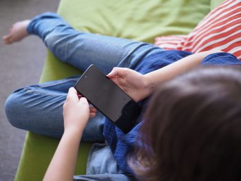 Midsection of woman using mobile phone