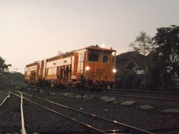 Train on railroad tracks against clear sky