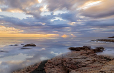 Rock formations against sky during sunset