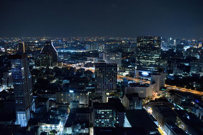 Aerial view of city lit up at night