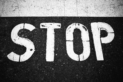 High angle view of arrow sign on road in city