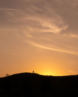 Scenic view of silhouette land against sky at sunset