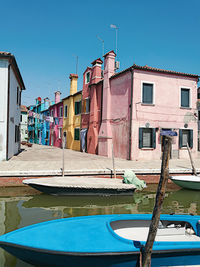 View of houses against clear blue sky