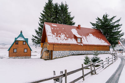 House on snow covered landscape