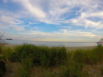 Scenic view of sea against cloudy sky