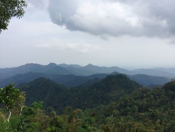 Scenic view of mountains against cloudy sky