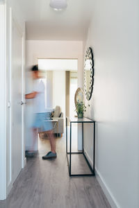 Woman walking in corridor at home