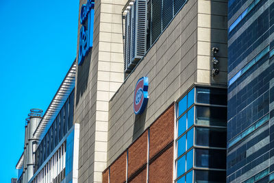Low angle view of modern buildings against blue sky