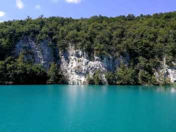 Crystal blue lake against rough mountains