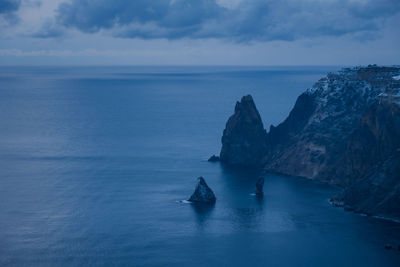 Cape fiolent crimea sevastopol. blue cloudy evening winter landscape with sea and rock. 