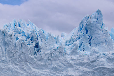 Snow covered landscape against sky