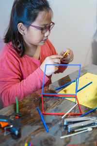 Portrait of girl with eyeglasses on table